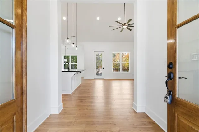 a view of a hallway with wooden floor and staircase