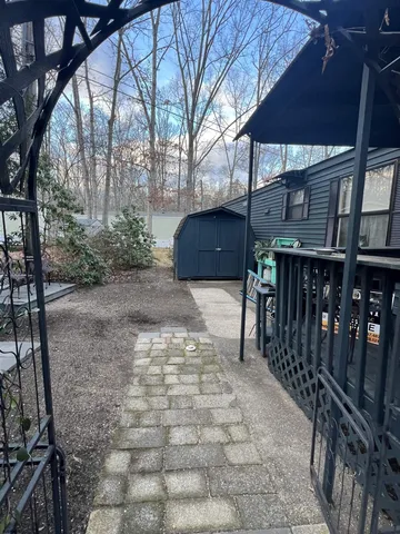 a view of a patio with table and chairs with wooden fence and plants