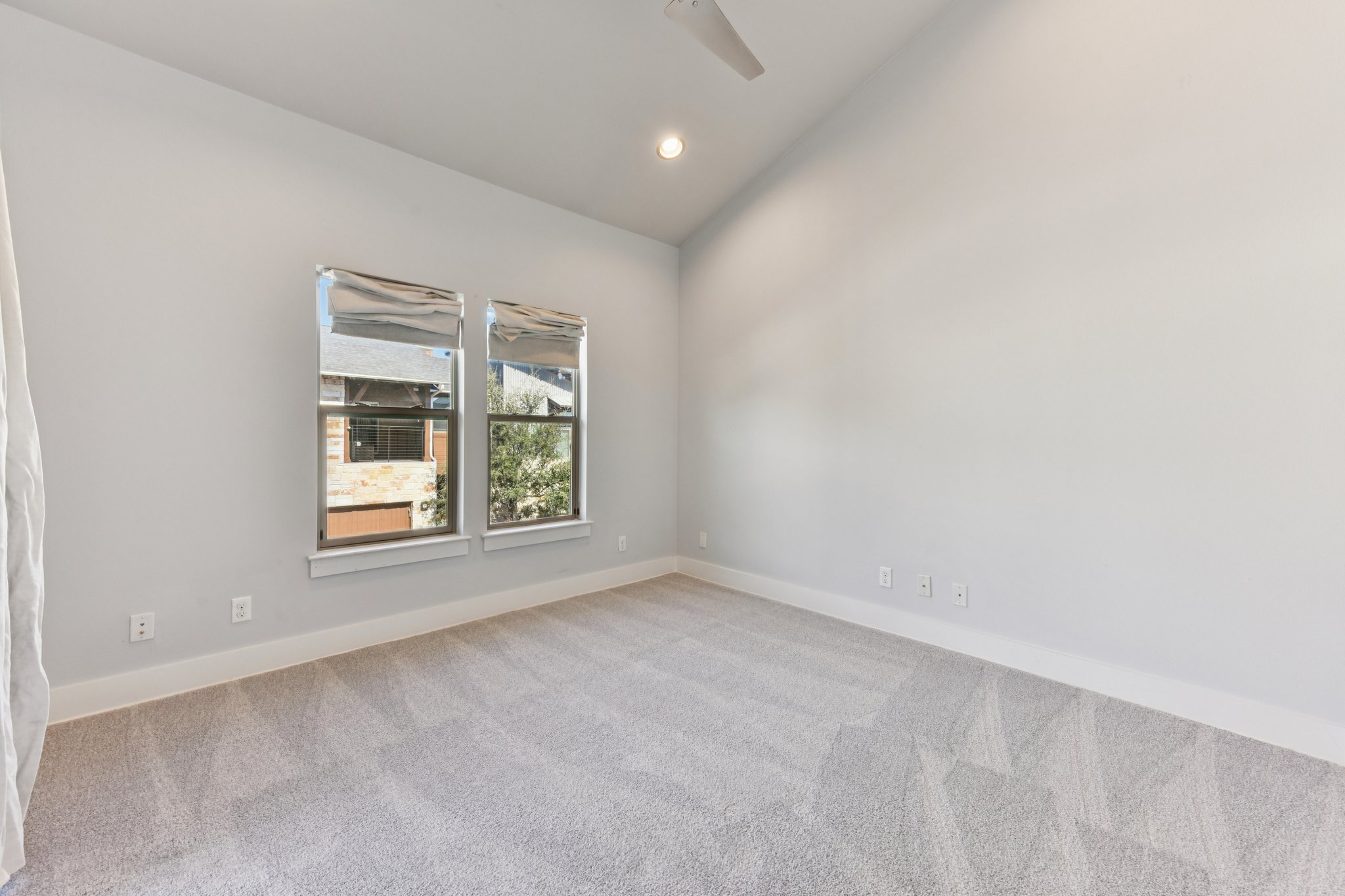 8110 Ranch Road 2222, Unit 98 Austin, TX 78730 - Photo 19 of 37 Spare room featuring vaulted ceiling, light colored carpet, and recessed lighting