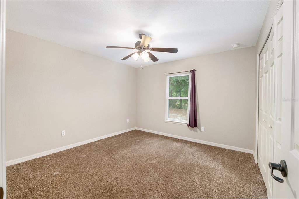 2 Hemlock Loop Drive Ocala, FL 34472 - Photo 22 of 28 an empty room with windows and fan