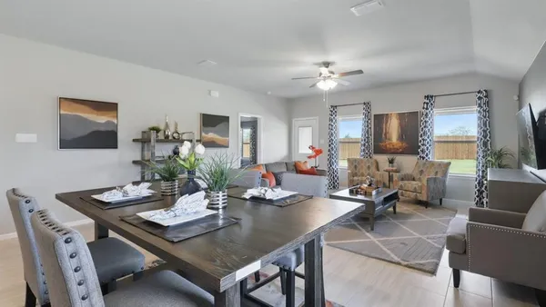 a kitchen with a dining table chairs and white appliances