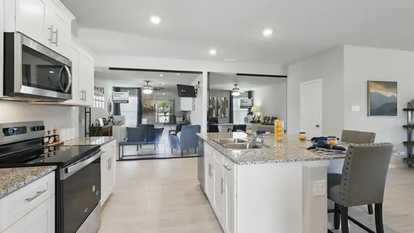 a kitchen with a sink stove and cabinets