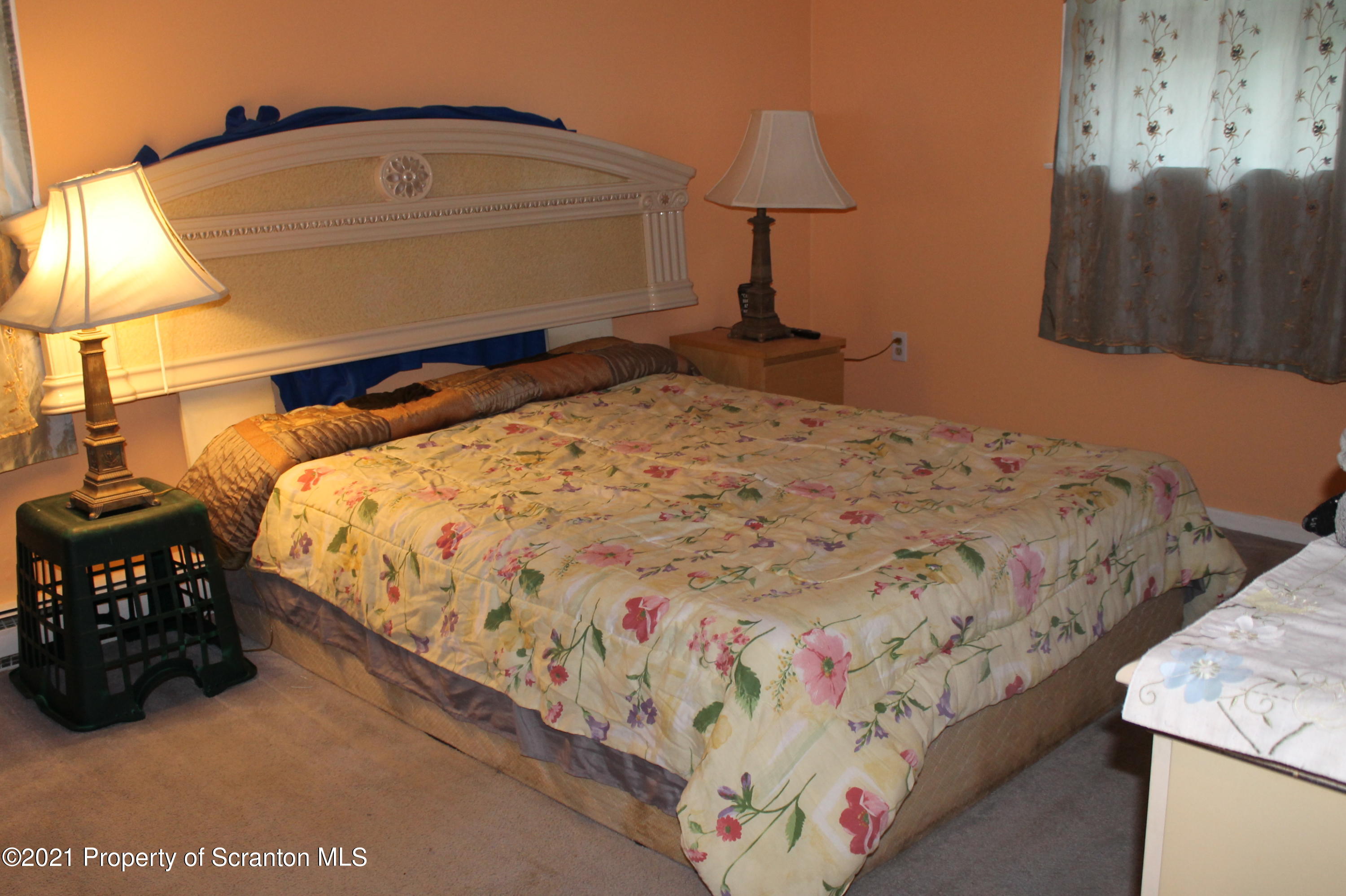 3431 Aberdeen Road Moscow, PA 18444 - Photo 6 of 28 a bed sitting in a bedroom next to a lamp