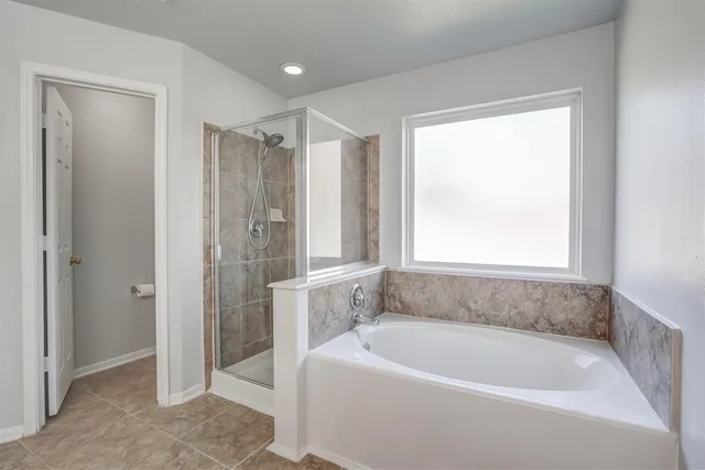 a white bath tub sitting next to a shower