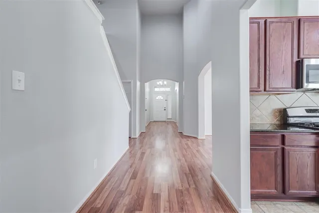 a view of hallway with wooden floor
