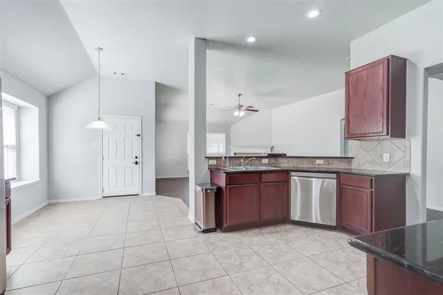 a view of kitchen with granite countertop cabinets and stainless steel appliances