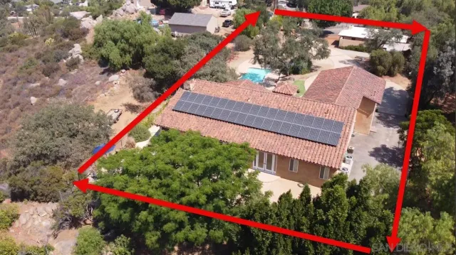 a kitchen with granite countertop a table chairs microwave and refrigerator