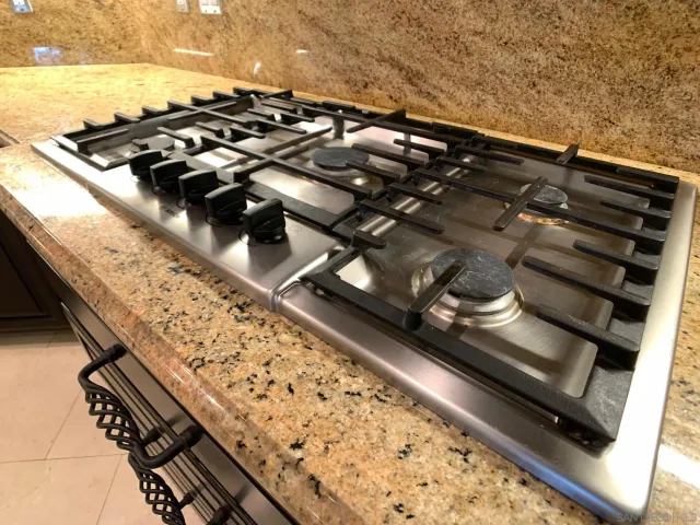 a bathroom with a sink a toilet a mirror and shower