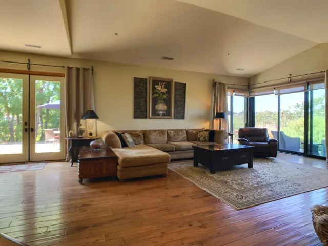 a bathroom with a granite countertop sink a toilet a mirror and shower
