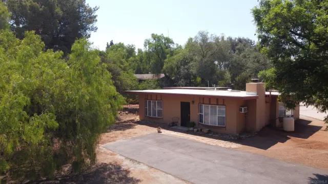 a view of house with outdoor space and trees