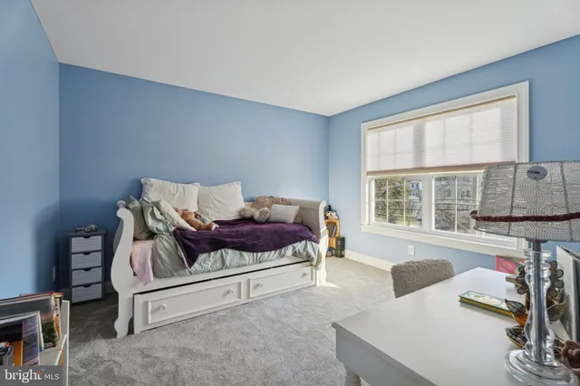 a bedroom with furniture and a large window