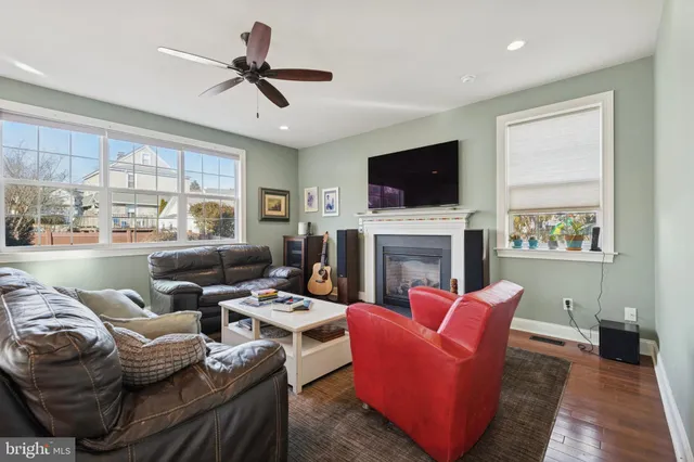a living room with fireplace furniture and a flat screen tv