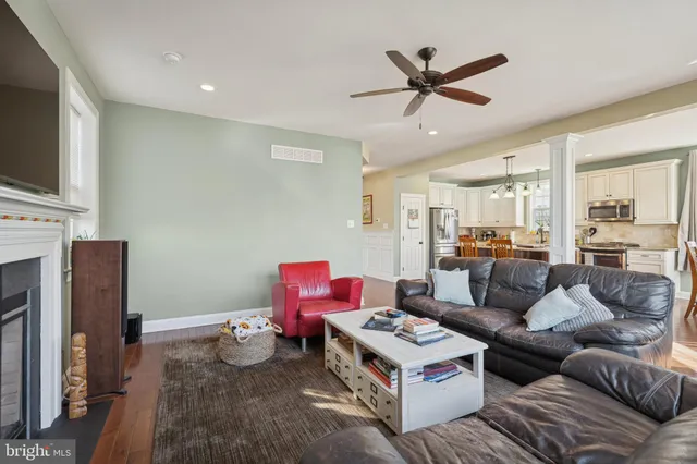 a living room with furniture kitchen view and a flat screen tv