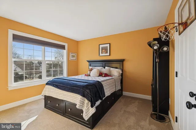 a bed sitting in a bedroom next to a window