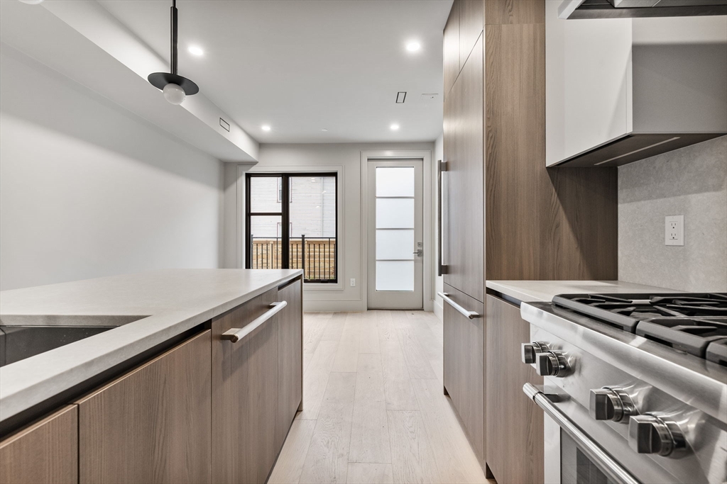 300 Franklin Street, Unit 2 Cambridge, MA 02139 - Photo 11 of 17 a kitchen with granite countertop a stove and a sink