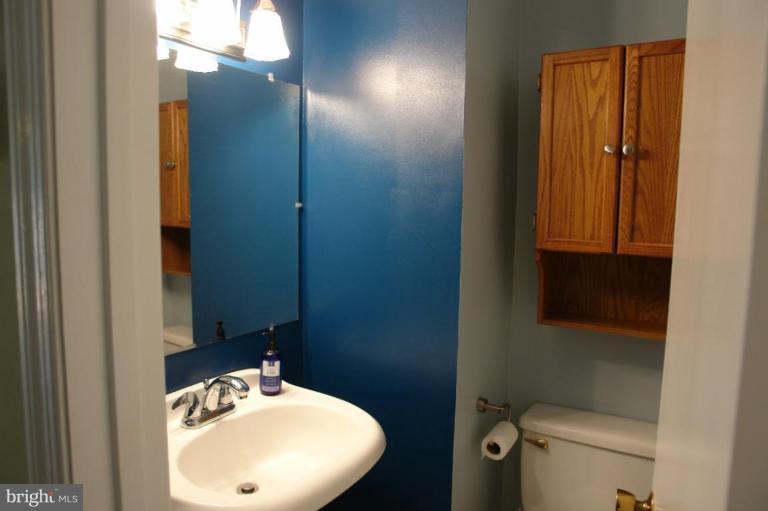 2440 Alsop Court Reston, VA 20191 - Photo 11 of 21 a bathroom with a sink and mirror with toilet