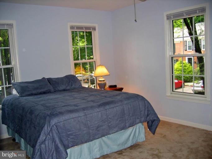 2440 Alsop Court Reston, VA 20191 - Photo 15 of 21 a bed sitting in a bedroom next to a window