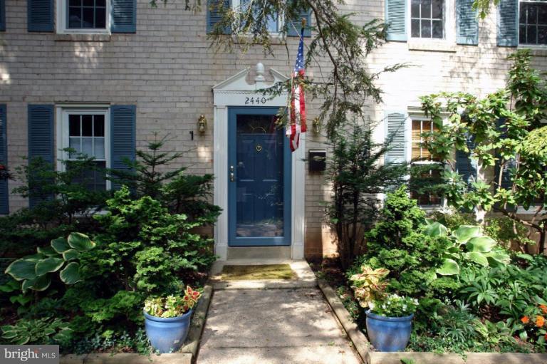 2440 Alsop Court Reston, VA 20191 - Photo 3 of 21 a front view of a house with a garden