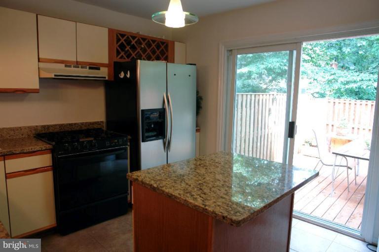 2440 Alsop Court Reston, VA 20191 - Photo 8 of 21 a kitchen with kitchen island granite countertop a stove refrigerator and microwave