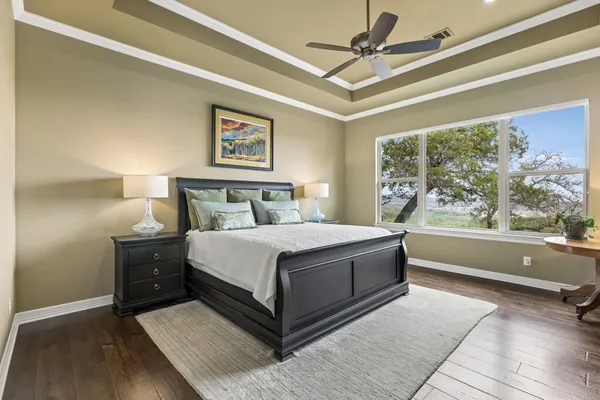 a bedroom with a large bed and a window