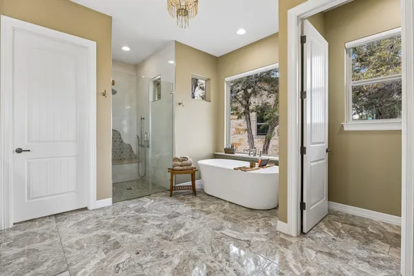 a living room with furniture a large window and wooden floor