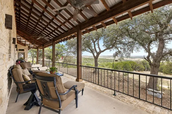 a view of porch with furniture and trees