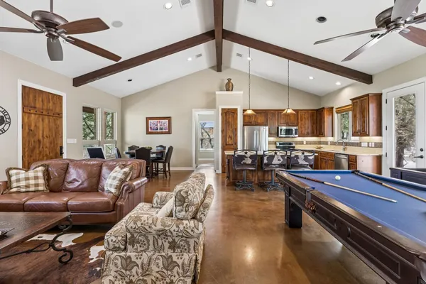 a living room with stainless steel appliances kitchen island granite countertop furniture and a kitchen view