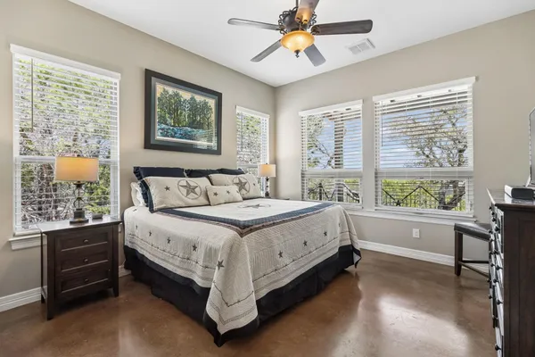 a spacious bedroom with a bed and a window