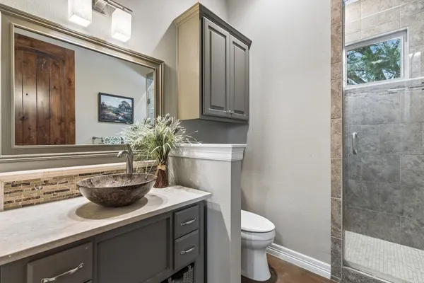 a bathroom with a toilet a sink and mirror