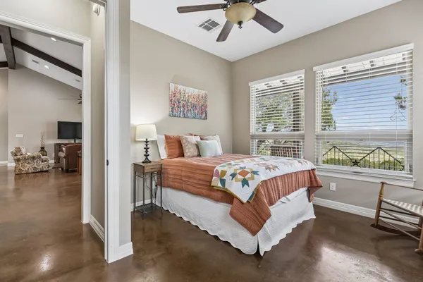 a bedroom with a large bed and a chandelier