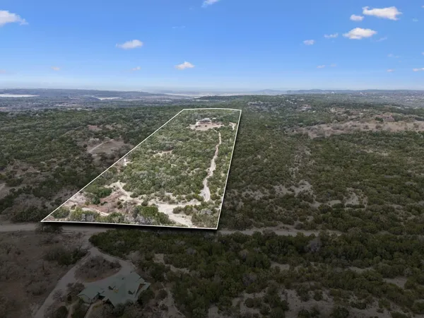 an aerial view of a residential houses with outdoor space