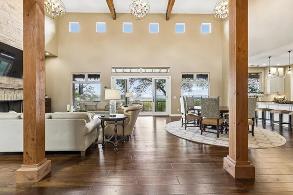 a dining room with wooden floor a glass table and chairs