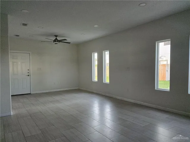 an empty room with windows and closet
