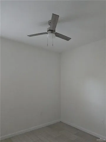 a room with a ceiling fan and a window
