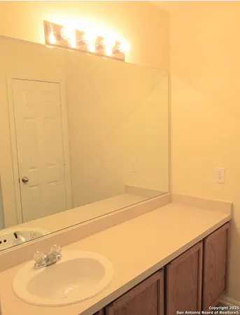 an empty room with windows and ceiling fan