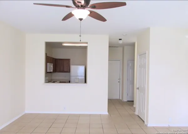a view of an empty room with a fan