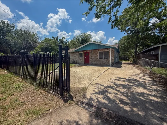a view of a house with a wooden fence