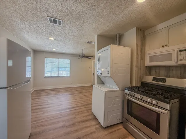 a kitchen with a stove and a refrigerator