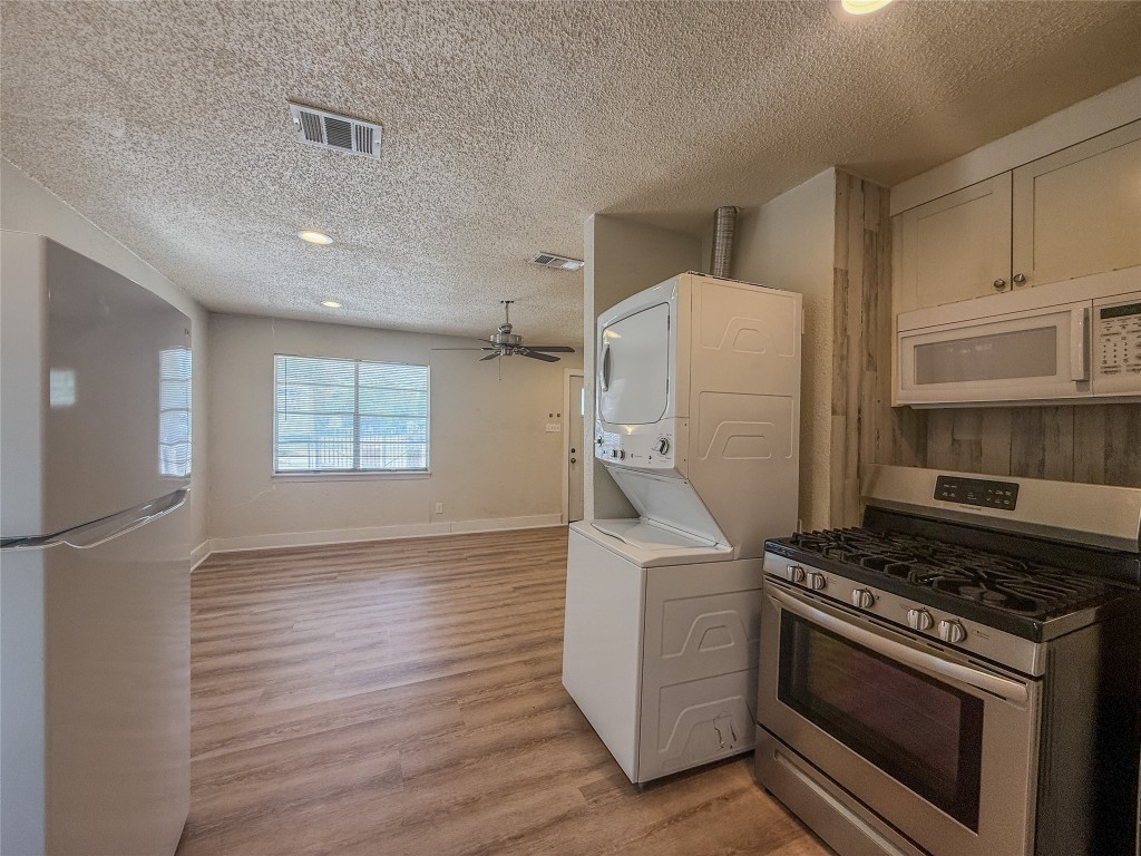 1412 Vargas Road, Unit A Austin, TX 78741 - Photo 20 of 32 a kitchen with a stove and a refrigerator