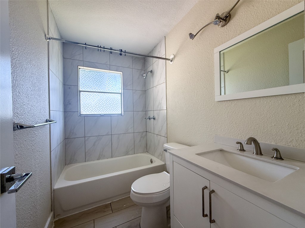 1412 Vargas Road, Unit A Austin, TX 78741 - Photo 27 of 32 a bathroom with a sink a toilet and shower