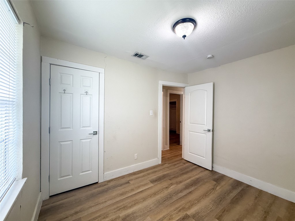 1412 Vargas Road, Unit A Austin, TX 78741 - Photo 28 of 32 an empty room with wooden floor and windows