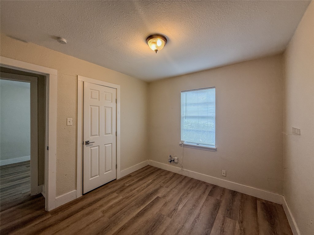 1412 Vargas Road, Unit A Austin, TX 78741 - Photo 30 of 32 an empty room with wooden floor and windows