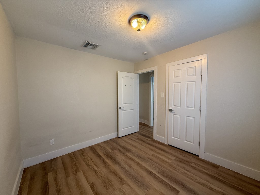 1412 Vargas Road, Unit A Austin, TX 78741 - Photo 31 of 32 a view of a room with wooden floor and a ceiling fan