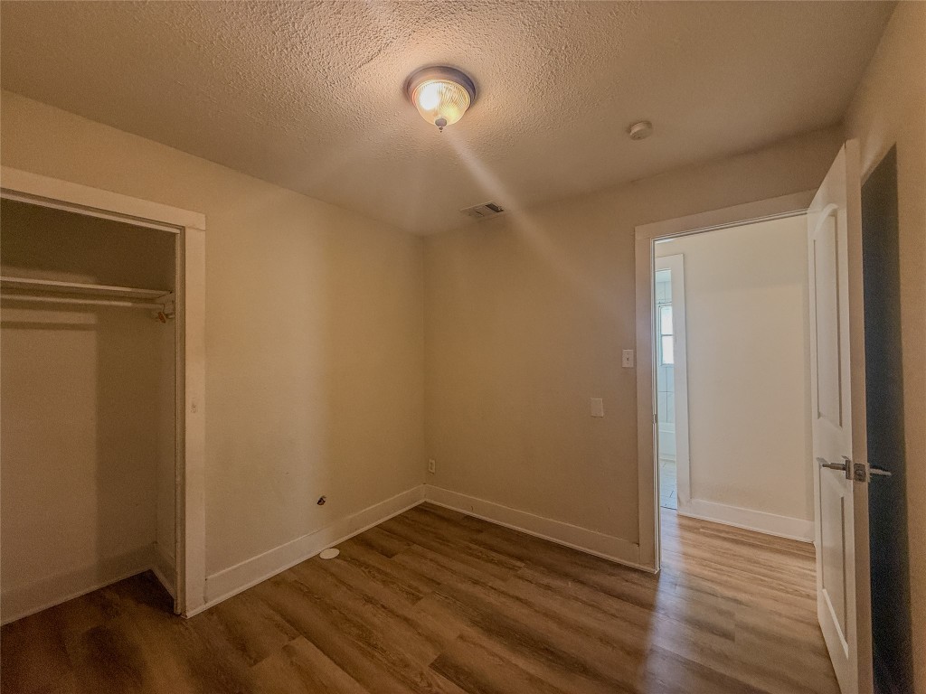 1412 Vargas Road, Unit A Austin, TX 78741 - Photo 32 of 32 a view of an empty room with wooden floor