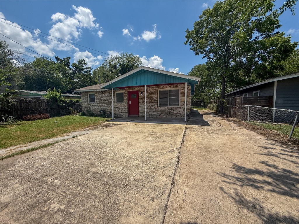 1412 Vargas Road, Unit A Austin, TX 78741 - Photo 10 of 32 a front view of a house with a yard and garage