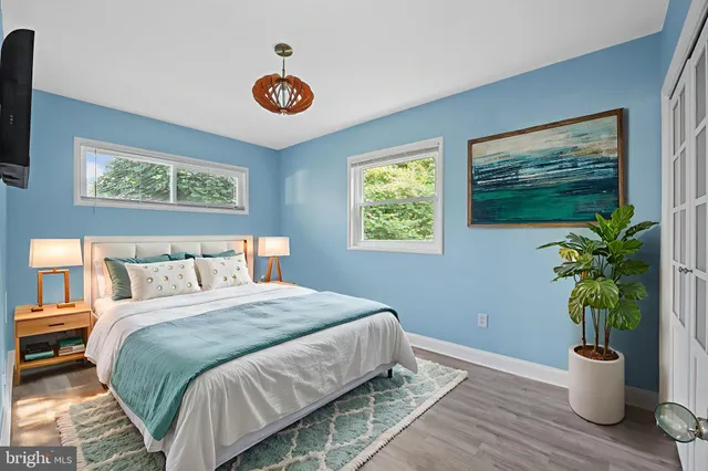 a bedroom with a bed and a potted plant