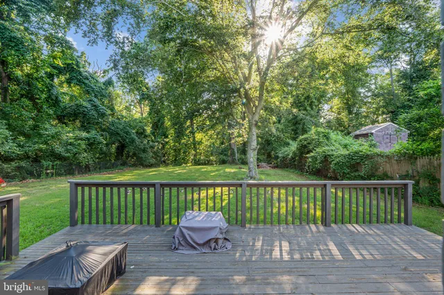 a view of a wooden deck with a big yard