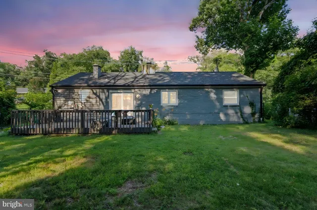 a view of a backyard with a small cabin and wooden fence