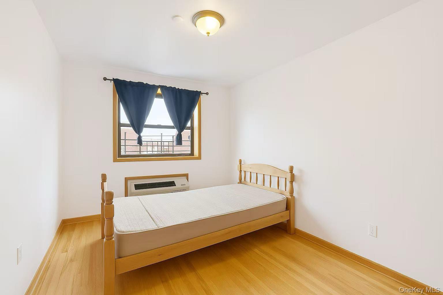 46-06 88th Street, Unit 5B Queens, NY 11373 - Photo 8 of 11 Bedroom with wood finished floors and baseboards