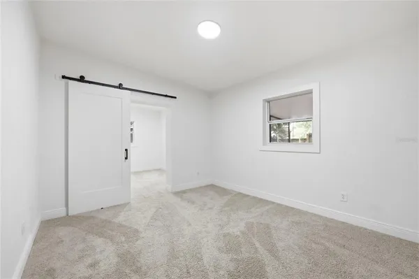 an empty room with a fan